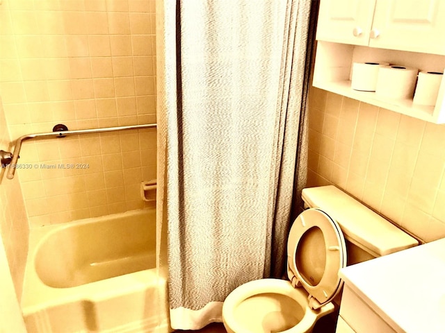 full bathroom featuring vanity, toilet, tile walls, and shower / tub combo with curtain