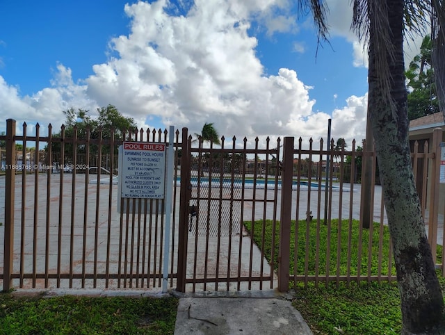 view of gate featuring a community pool