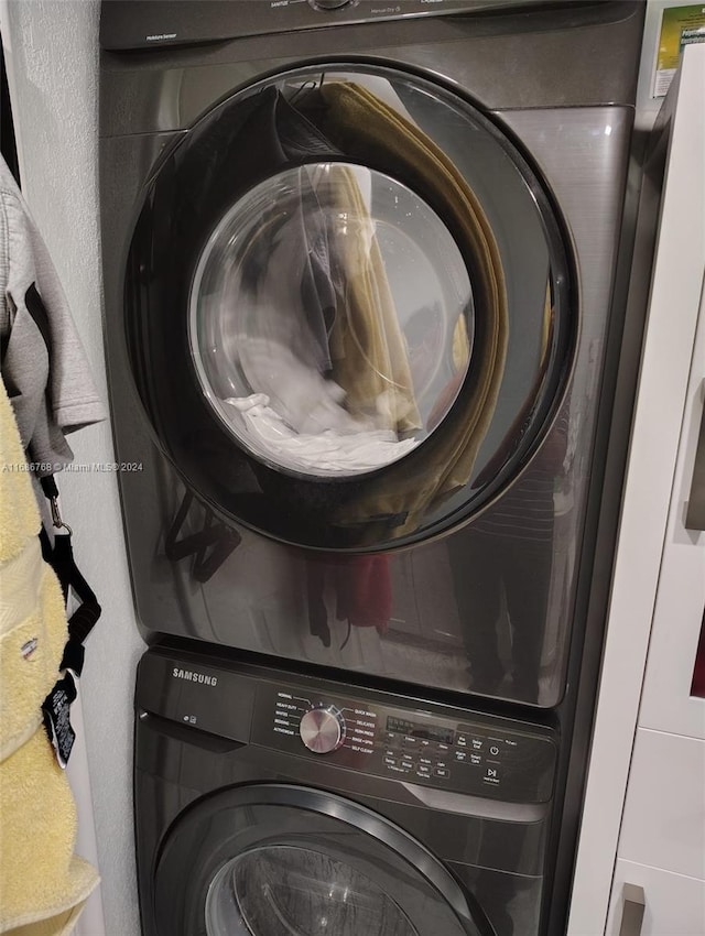 washroom with stacked washer / drying machine