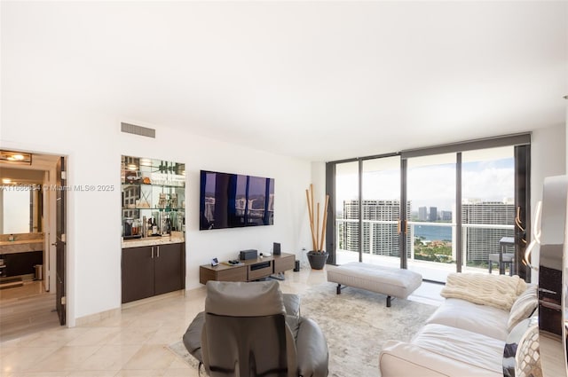 living room with plenty of natural light, expansive windows, and light tile patterned flooring