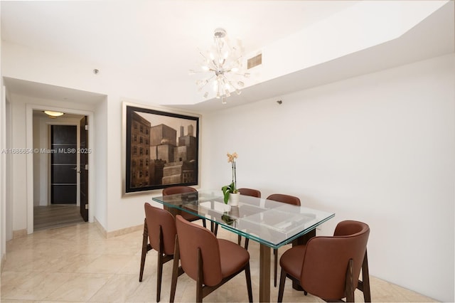 dining area with an inviting chandelier