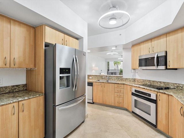 kitchen with light stone countertops, light brown cabinets, sink, and stainless steel appliances