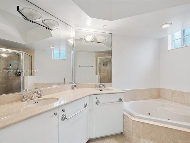 bathroom featuring independent shower and bath, tile patterned flooring, and vanity