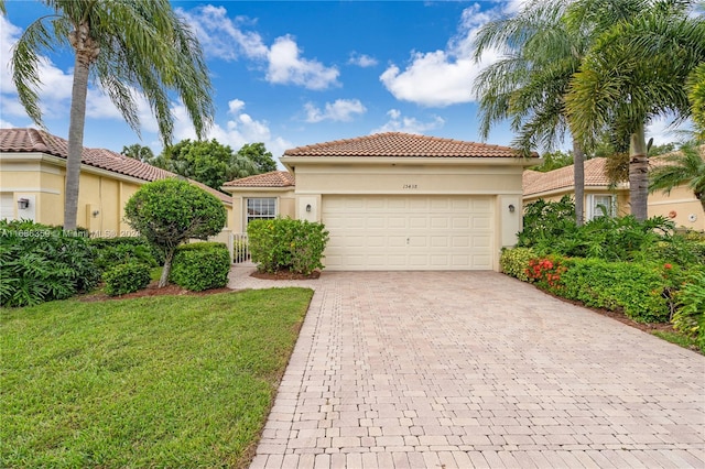 mediterranean / spanish-style house with a front yard and a garage