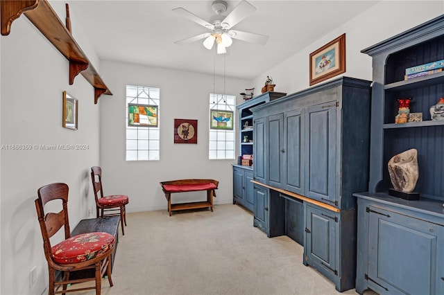 living area featuring ceiling fan and light colored carpet