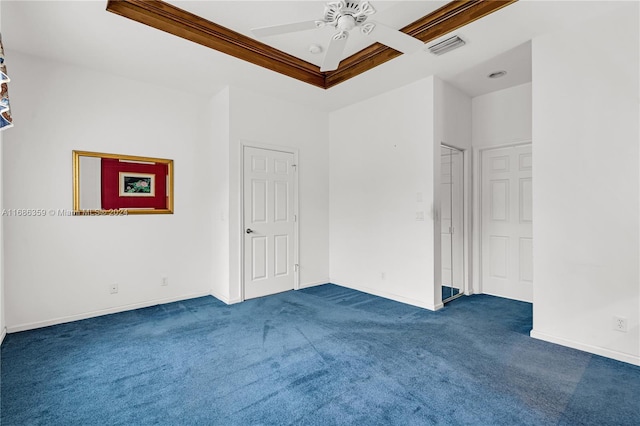 unfurnished room with ceiling fan and dark colored carpet