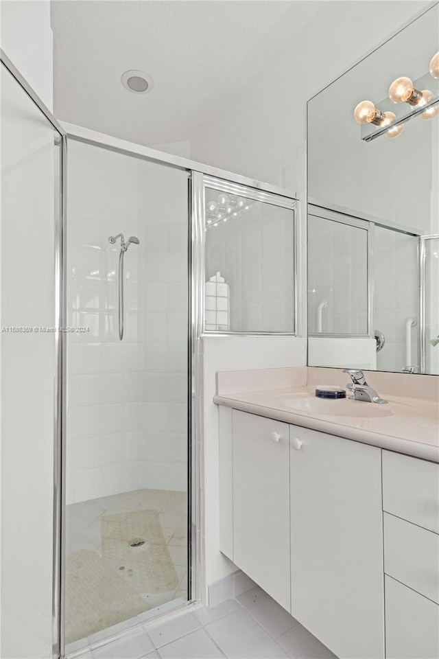 bathroom with vanity, walk in shower, and tile patterned floors