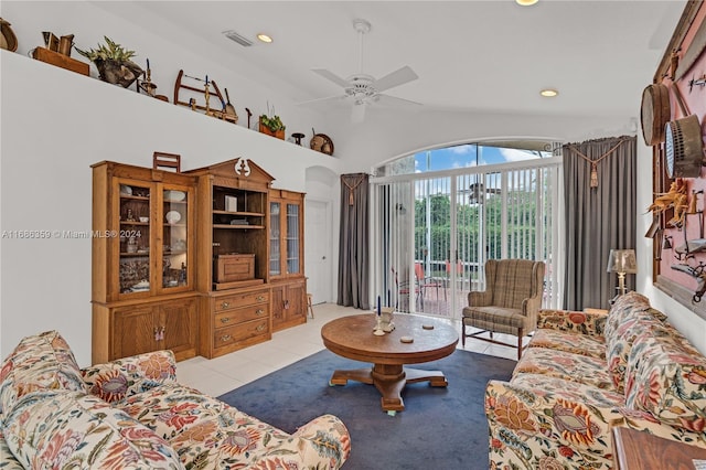 living room featuring lofted ceiling, light tile patterned floors, and ceiling fan