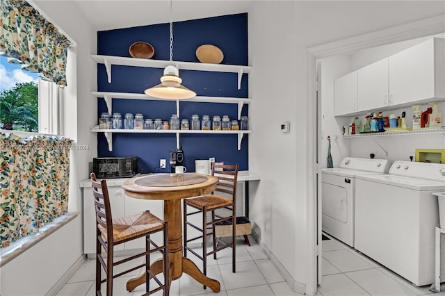 tiled dining space with washing machine and clothes dryer