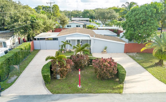 view of front of home with a front yard and a garage