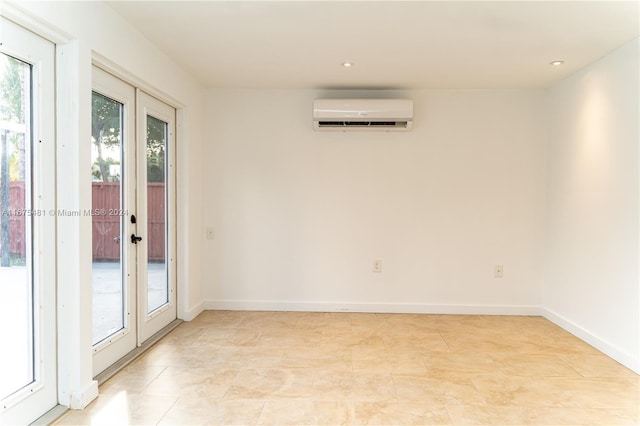 unfurnished room with french doors and an AC wall unit