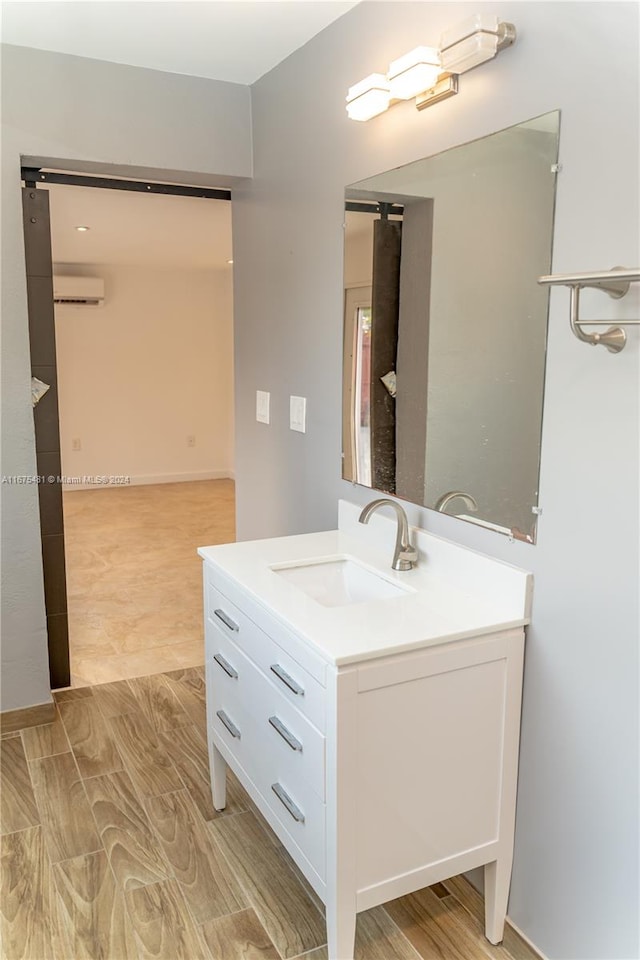 bathroom featuring vanity, an AC wall unit, and wood-type flooring