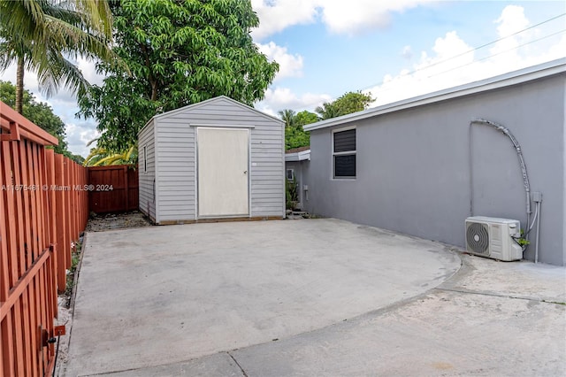 view of patio featuring a shed and ac unit