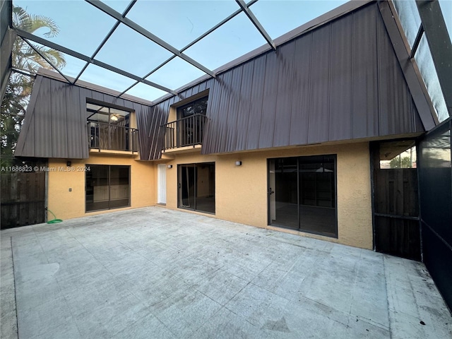 back of house with a patio, a lanai, and a balcony