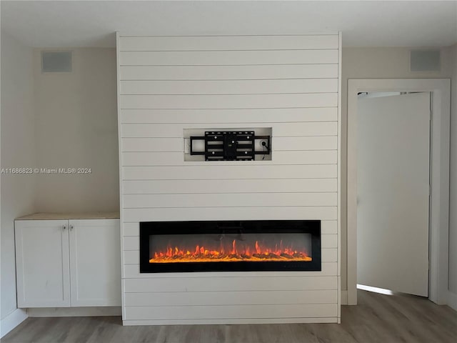 interior details with hardwood / wood-style floors and a fireplace