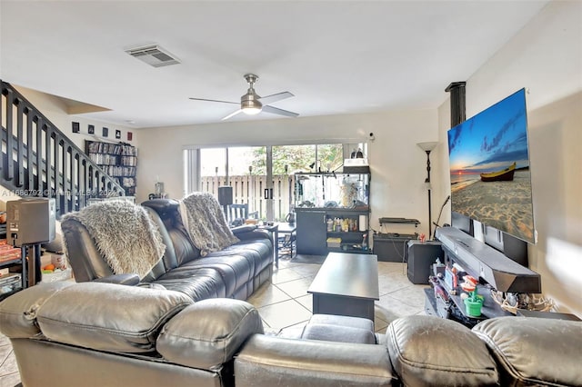 tiled living room with ceiling fan