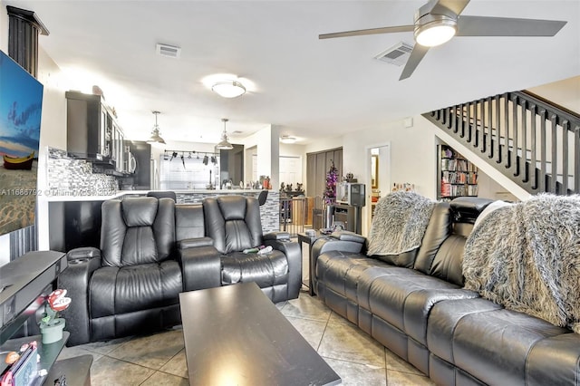 living room with ceiling fan and light tile patterned flooring