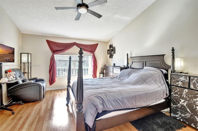 bedroom featuring ceiling fan, wood-type flooring, and a textured ceiling