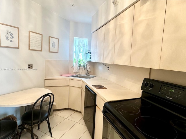 kitchen with light tile patterned floors, sink, and black appliances