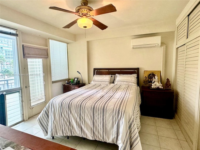 bedroom featuring a wall mounted air conditioner, light tile patterned floors, access to outside, and ceiling fan