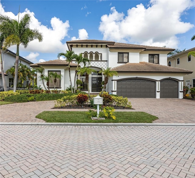 mediterranean / spanish-style house with a garage