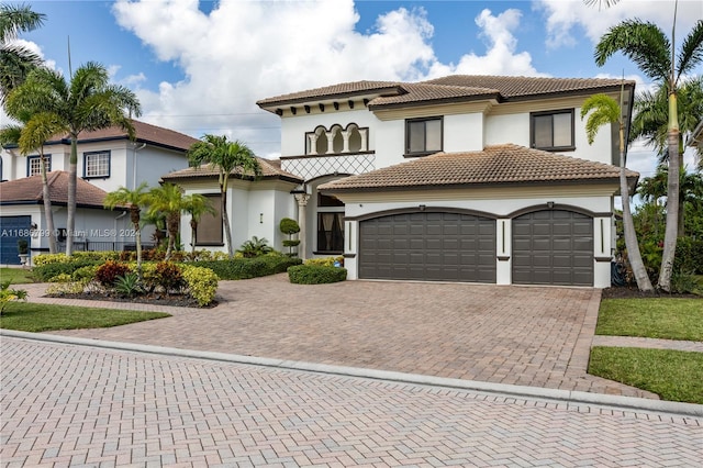 mediterranean / spanish-style home with a garage