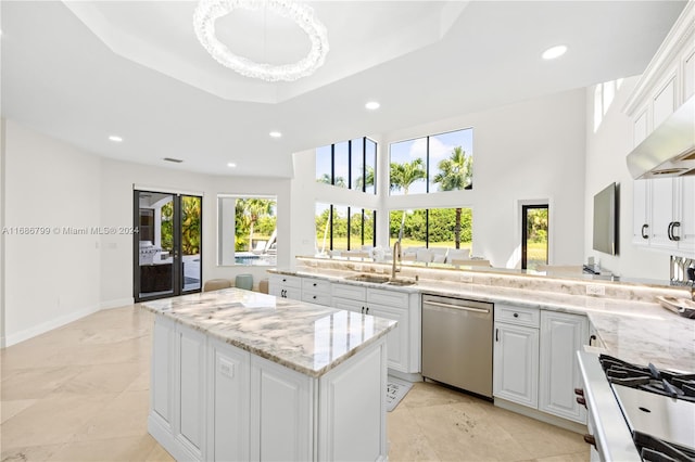 kitchen with dishwasher, a healthy amount of sunlight, white cabinets, and sink