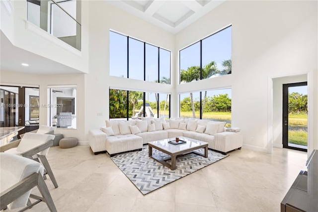 tiled living room with a high ceiling, beam ceiling, and coffered ceiling