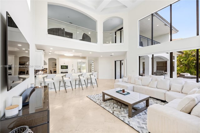 tiled living room with a towering ceiling