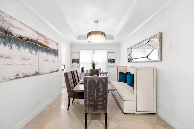 dining room with light tile patterned flooring, ornamental molding, and a raised ceiling