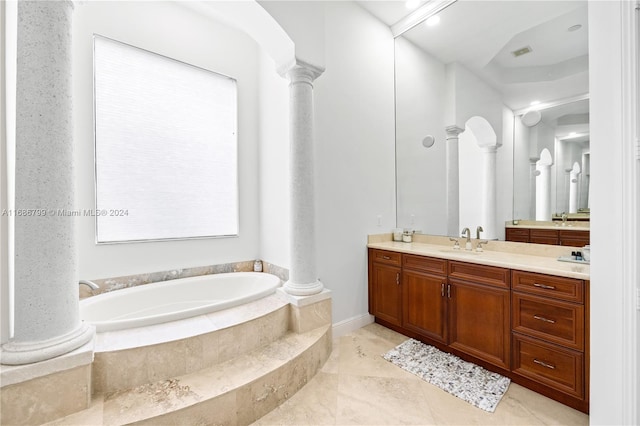 bathroom with vanity and a relaxing tiled tub