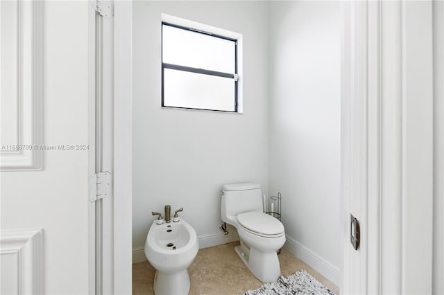 bathroom featuring a bidet, tile patterned floors, and toilet