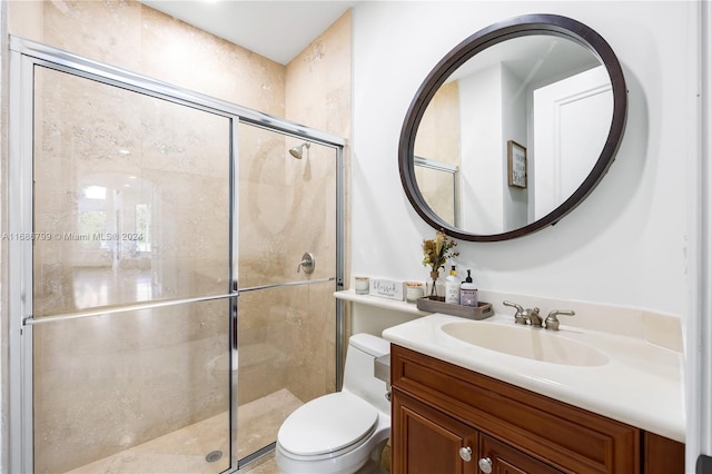 bathroom with walk in shower, vanity, and toilet