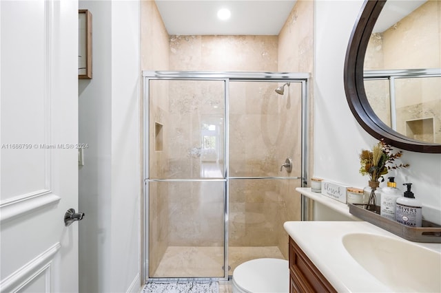 bathroom with vanity, toilet, and an enclosed shower