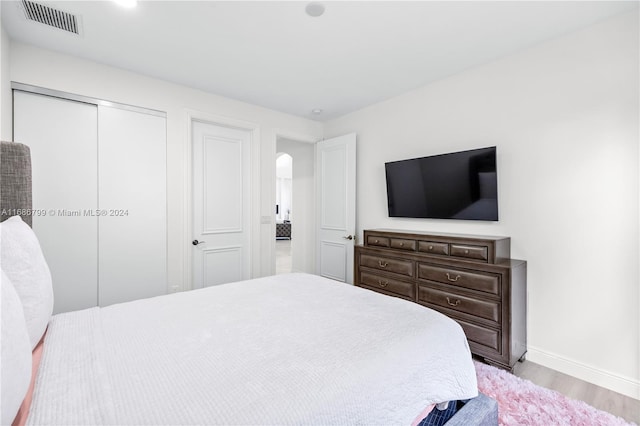 bedroom featuring light wood-type flooring and a closet