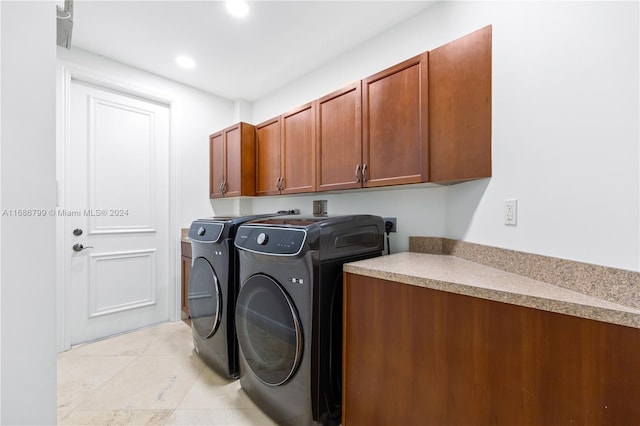 laundry area with cabinets and washing machine and dryer