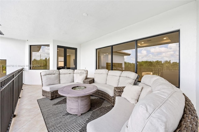 tiled living room featuring a textured ceiling