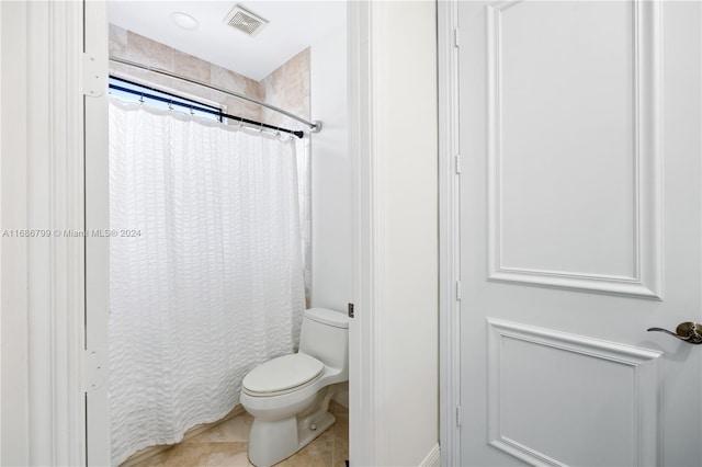 bathroom with tile patterned flooring, toilet, and a shower with curtain