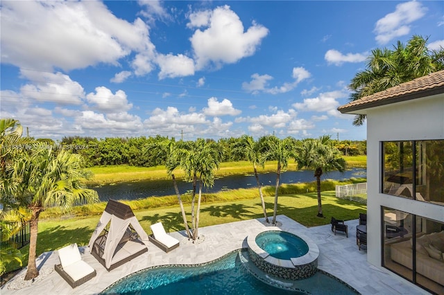 view of pool featuring a yard, an in ground hot tub, a water view, and a patio area