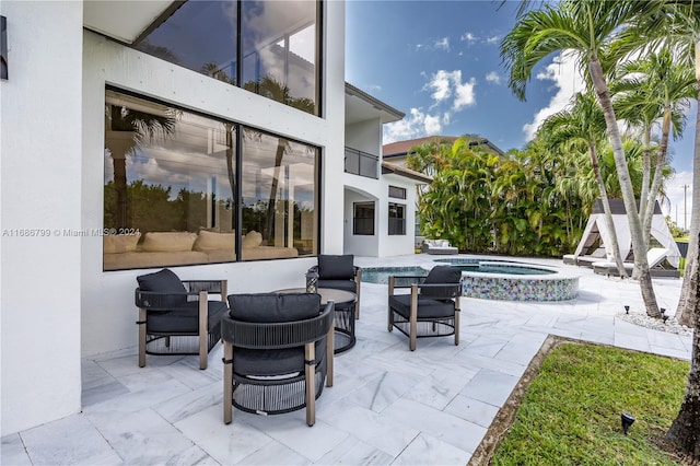 view of patio / terrace with outdoor lounge area and a pool with hot tub