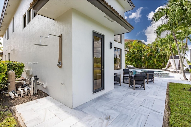 view of patio with an in ground hot tub