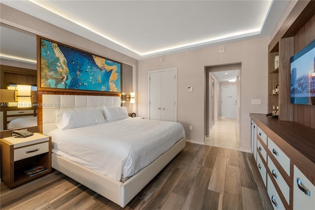 bedroom featuring a closet and dark hardwood / wood-style floors