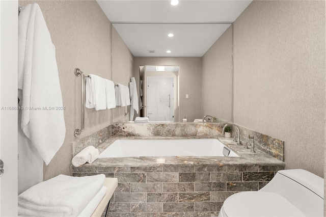 bathroom featuring plus walk in shower and toilet