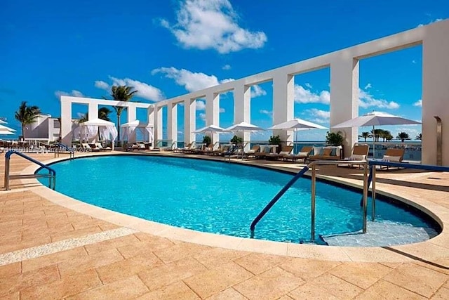 view of swimming pool featuring a patio area