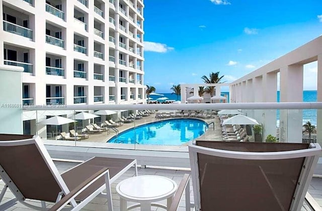 view of swimming pool featuring a water view