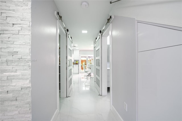 hallway featuring a barn door