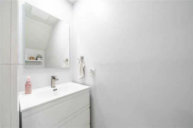 bathroom with vanity and vaulted ceiling