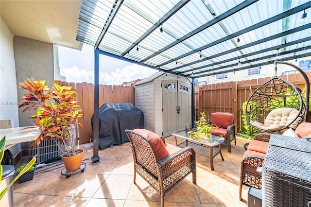 view of patio with a shed, grilling area, and outdoor lounge area