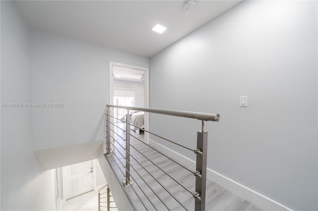 stairs featuring hardwood / wood-style floors