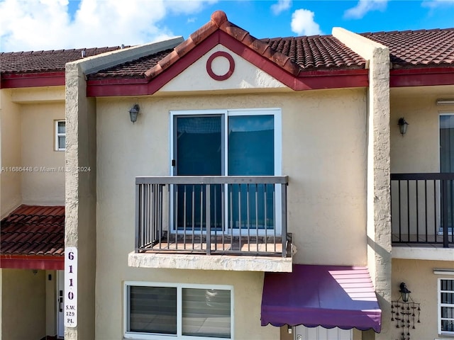 view of side of home with a balcony